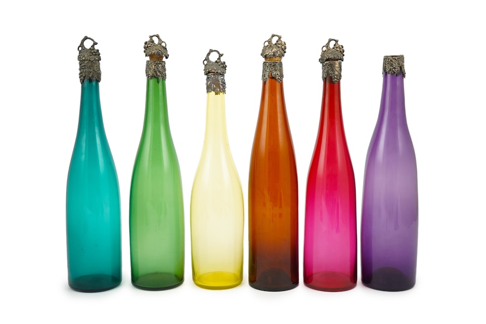 A composed set of six mid 19th century vari-coloured glass carafes